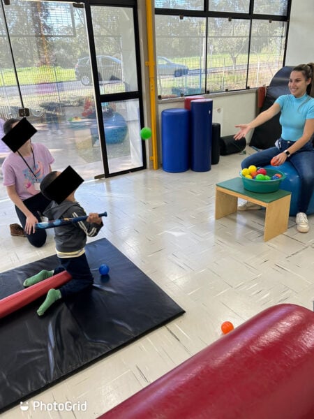 Balance training in a high kneeling position while playing baseball. 